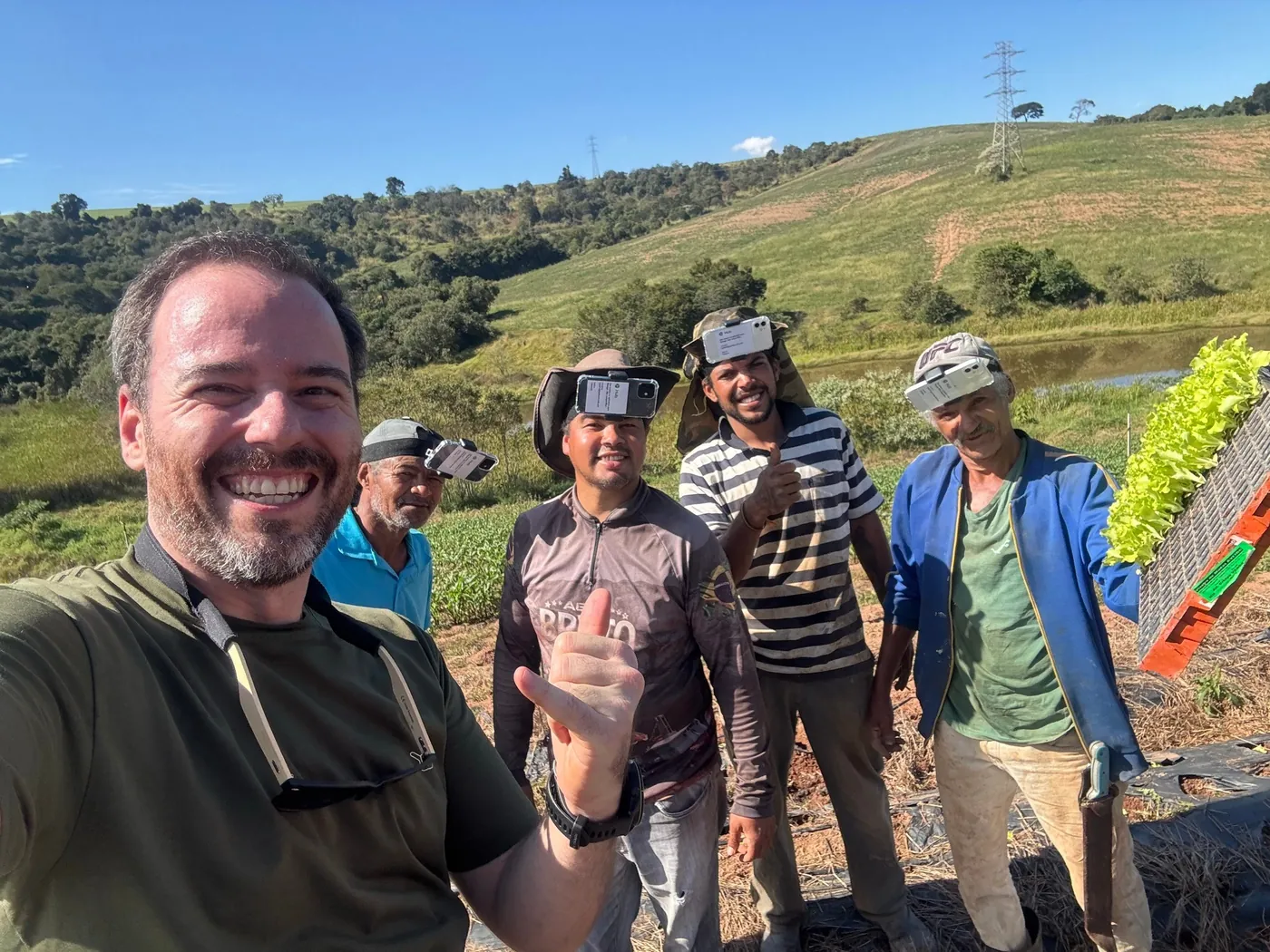 A Hub field team on a farm hillside in Brazil, head rigs on